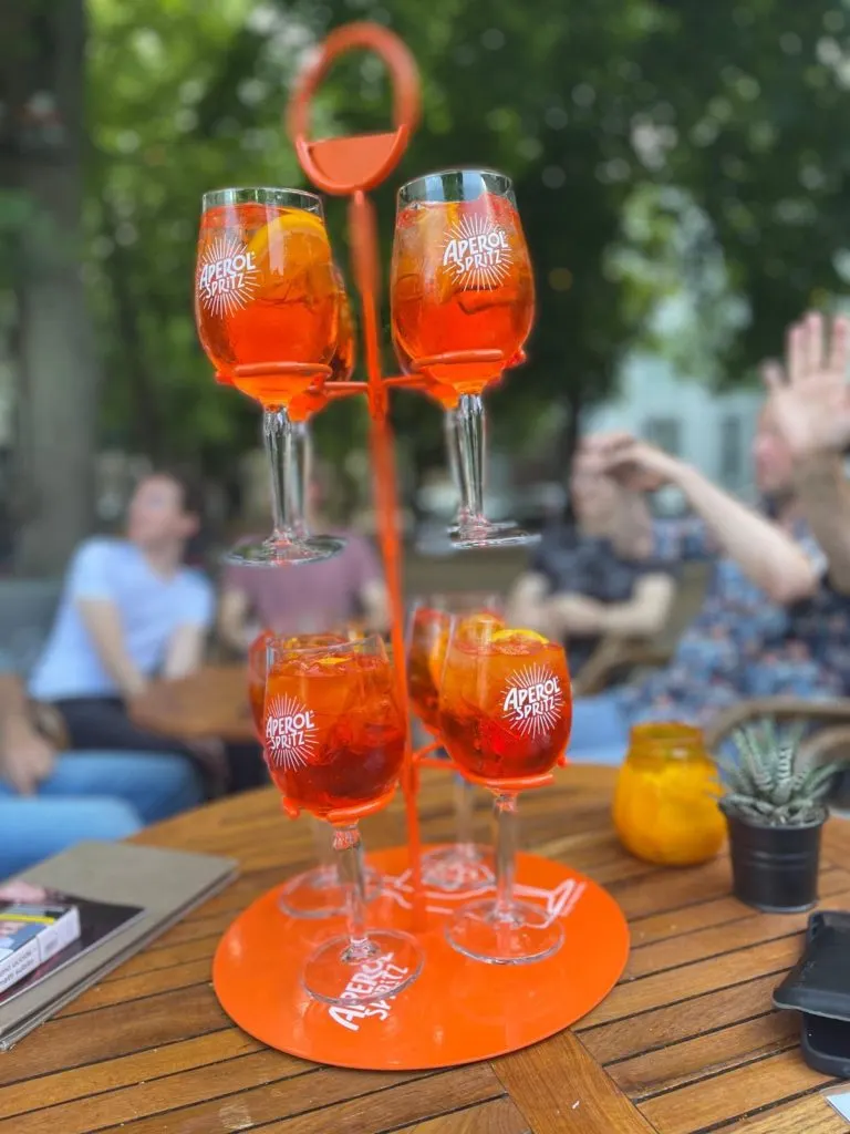 Tower of Aperol Spritz glasses on a table on the terrace of Restobar LURE